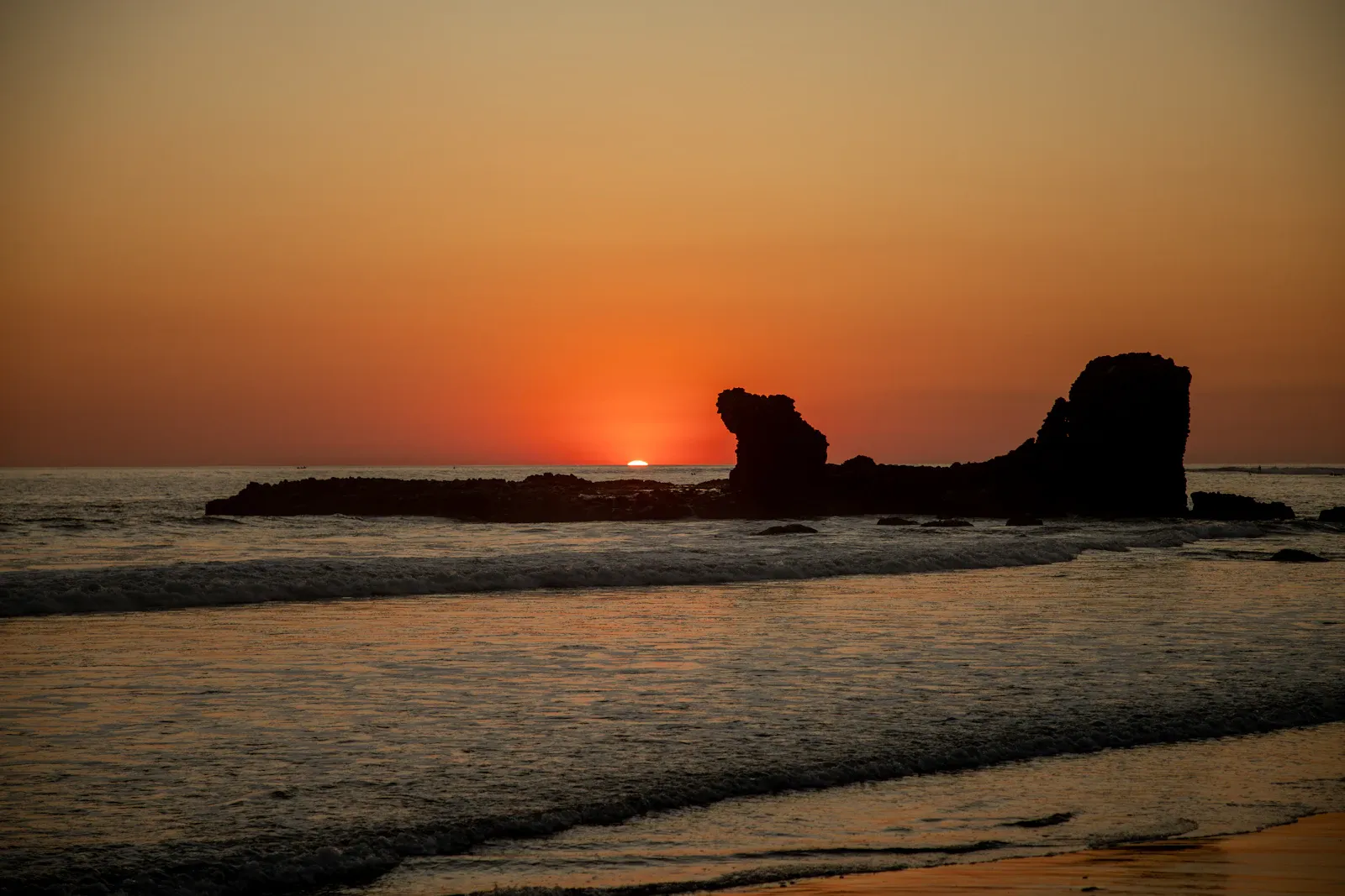 The rock formation off El Tunco beach silhouetted at sunset