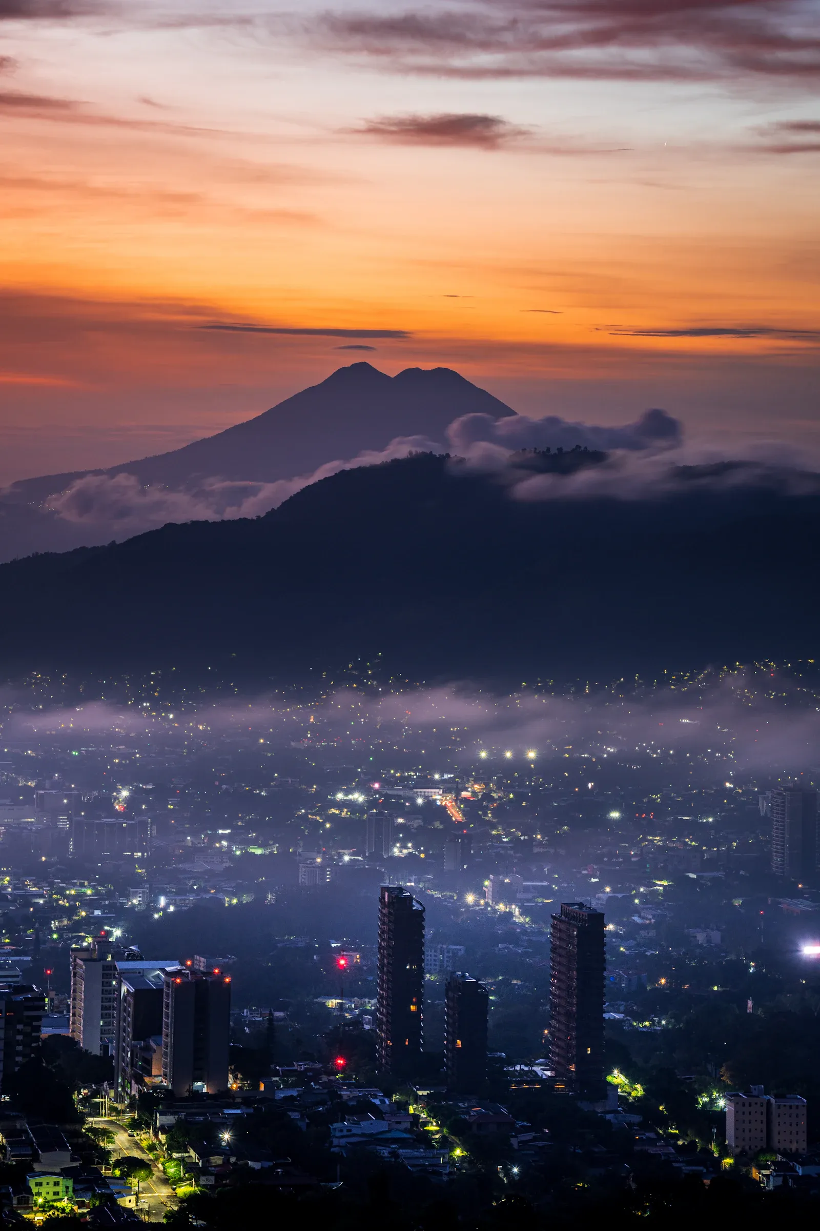 San Salvador rooftops with the volcano rising behind the city